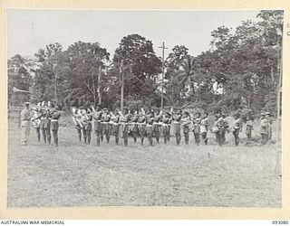 LAE AREA, NEW GUINEA, 1945-06-16. THE PAPUAN INFANTRY DEPOT BATTALION CONDUCTED BY BANDMASTER, LT J. RYDER (1), PLAYING THE "GENERAL SALUTE". A PARADE TO COMMEMORATE WATERLOO DAY WAS HELD BY ALL ..