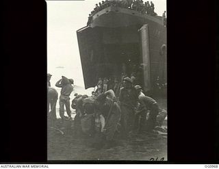 AITAPE AREA, NORTH EAST NEW GUINEA. C. 1944-04-22. RAAF PERSONNEL OF MOBILE WORKS, SURVEY AND SIGNALS UNITS PREPARE A TRACK TO ENABLE HEAVY EQUIPMENT TO BE BROUGHT ASHORE FROM A LANDING SHIP, TANK ..