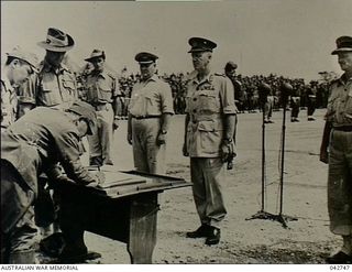 Cape Wom, Wewak, New Guinea. 1945-09-13. Lieutenant General Hatazo Adachi, General Officer Commanding XVIII Japanese Army, watched by Major General H. C. H. Robertson, General Officer Commanding 6 ..