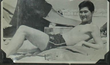 Japanese American man lounging on Hawaiian beach