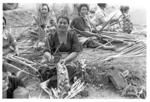 Women making baskets for food from the earth ovens.