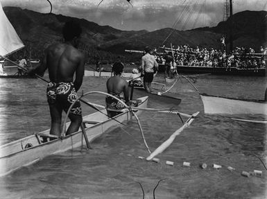 [Outrigger canoes and a crowded passenger ship on the water]