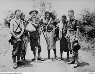 1943-10-01. NEW GUINEA. FALL OF LAE. D.O.I. PHOTOGRAPHERS, ROY DRIVER AND GORDON SHORT PHOTOGRAPHED WITH F. MCKEHNIE AT LAE
