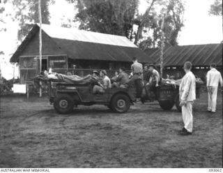 LALUM, BOUGAINVILLE, 1945-06-12. JEEP AND TRAILER OF 19 FIELD AMBULANCE LOADED WITH STRETCHER CASES FOR TRANSPORTATION FROM MAIN DRESSING STATION TO THE HOSPITAL SHIP STRADBROKE. THE PATIENTS, ..