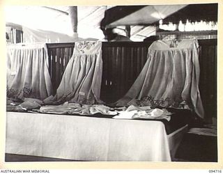 LAE AREA, NEW GUINEA, 1945-08-04. THE FANCY WORK SECTION AT THE ARTS AND CRAFTS EXHIBITION HELD AT THE RED CROSS SOCIETY HUT, 2/7 GENERAL HOSPITAL. BOTH HOSPITAL STAFF AND PATIENTS PLACED ENTRIES ..