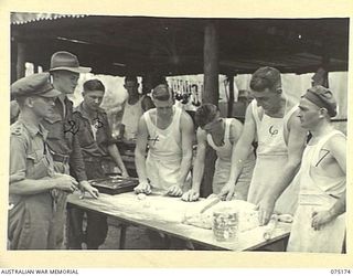 SIAR, NEW GUINEA. 1944-08-09. NX137071 LIEUTENANT R.S. MCGOVERN, CATERING ADVISER, HEADQUARTERS, 5TH DIVISION (1) WATCHING COOKS PREPARE BREAD ROLLS FOR BAKING IN THE COOKHOUSE OF HEADQUARTERS, ..