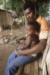 Father with his son who is holding a machete