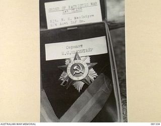 HERBERTON, QUEENSLAND, AUSTRALIA. 1944-10-11. THE ORDER OF PATRIOTIC WAR FIRST CLASS, PRESENTED TO NX40550 SERGEANT N.S. MACINTYRE, 2/ 4TH INFANTRY BATTALION. THIS IS THE FOURTH SUCH AWARD ..