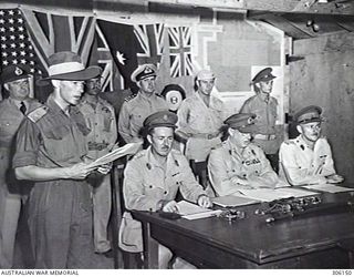 BOUGAINVILLE, SOLOMON ISLANDS. 1945-09-08. THE ALLIED OFFICIALS AT THE SIGNING OF THE INSTRUMENT OF SURRENDER OF THE JAPANESE FORCES ON BOUGAINVILLE. LIEUTENANT GENERAL SIR STANLEY G. SAVIGE KBE,CB ..