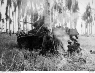 GIROPA POINT, PAPUA. 1943-01-02. AUSTRALIAN MANNED GENERAL STUART M3 TANKS ATTACK JAPANESE PILLBOXES IN THE FINAL ASSAULT ON BUNA. AMID SHELL TORN COCONUT TREES, A MORTAR CREW FROM D COMPANY, ..