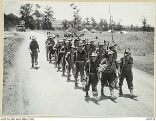 DALLMAN RIVER, NEW GUINEA, 1944-02-23. MEMBERS OF THE 64TH BATTERY, 2/14TH FIELD REGIMENT ON A TRAINING MARCH DURING INFANTRY EXERCISES AT THE COMPLETION OF THE HUON PENINSULA CAMPAIGN. IDENTIFIED ..