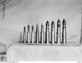 FINSCHHAFEN - SIO AREA, NEW GUINEA, 1944-03-31. JAPANESE AMMUNITION COLLECTED FROM DUMPS IN THE AREA BY THE CHIEF ENGINEER'S BRANCH, HEADQUARTERS 2ND AUSTRALIAN CORPS. THE AMMUNITION DISPLAYED, ..