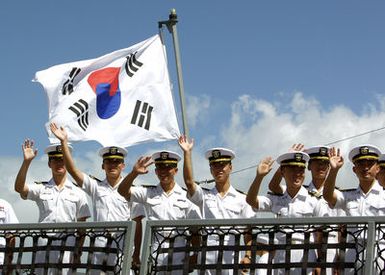 Republic of Korea Navy Sailors from the Chungmugong Yi Sun-sin Class (KDX-2) Destroyer DAE JO YEONG (DDG 977) and the Cheonji Class Fast Combat Support Ship DAE CHEONG (AOE 58), wave as they arrive for a port visit at at U.S. Naval Station Pearl Harbor, Hawaii, on Sept. 21, 2006. While in Hawaii, the Korean sailors plan to visit the National Memorial Cemetery of the Pacific and meet with members of the local Korean community. (U.S. Navy photo by CHIEF Mass Communication SPECIALIST David Rush) (Released)