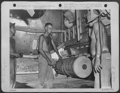 Armorers Load 500 Pound Incendiary Bomb Into Bomb Bays Of A Boeing B-29 "Superfortress" In Preparation For Bombing Mission Over Tokyo, Japan. Isely, Field, Saipan, Marianas Islands, 29 November 1944. (U.S. Air Force Number 64301AC)