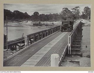 BOUGAINVILLE. 1945-05-16. A 3 TON TRUCK CROSSING THE NEWLY CONSTRUCTED MCKINNA BRIDGE OVER THE PURIATA RIVER. AN AUSTPANEL BRIDGE CONSTRUCTED BY 15 FIELD COMPANY, ROYAL AUSTRALIAN ENGINEERS, IT IS ..