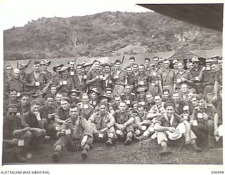 RABAUL, NEW BRITAIN, 1945-09-13. A GROUP OF MEMBERS OF 4 FIELD REGIMENT ENJOY A TEA BREAK AFTER WORKING AT PRESSURE TO ESTABLISH URGENTLY REQUIRED HOSPITAL FACILITIES TO RECEIVE A LARGE INTAKE OF ..