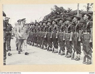 TOROKINA, BOUGAINVILLE, 1945-06-13. THE GOVERNOR GENERAL OF NEW ZEALAND, MARSHAL OF THE ROYAL AIR FORCE, SIR CYRIL L.N. NEWALL (2); INSPECTING THE AUSTRALIAN GUARD OF HONOUR, 7 INFANTRY BRIGADE, AT ..