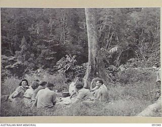 LAE, NEW GUINEA, 1945-05-18. PERSONNEL FROM THE AUSTRALIAN WOMEN'S ARMY SERVICE BARRACKS ENJOYING A PICNIC PARTY ON THE BANKS OF THE BUSU RIVER DURING A TOUR OF THE AREA ARRANGED BY ARMY AMENITIES ..