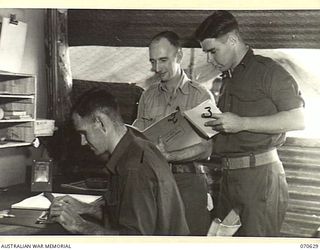 PORT MORESBY, PAPUA, 1944-02-26. CORPORAL CASTLEY (1), PRIVATE A. ALLEN (2) AND PRIVATE R. ADAMS (3), IN THE CANTEEN OFFICE AT THE 2/1ST GENERAL HOSPITAL