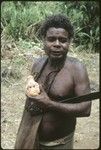 Portrait of a man, Batalamo, holding a doll head and a bush knife