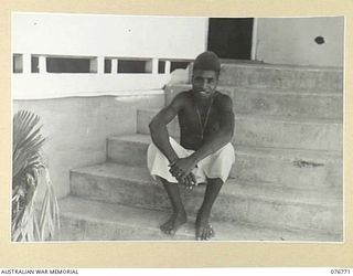 MADANG, NEW GUINEA. 1944-10-29. A NATIVE BOY WHO IS THE PERSONAL SERVANT OF COMMANDER J.C. MORROW, DSO, DSC, RAN