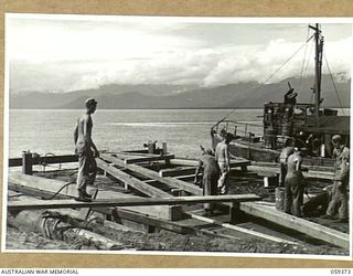 LAE, NEW GUINEA, 1943-11-05. ENGINEERS OF THE 1052ND ENGINEERS PORT CONSTRUCTION AND REPAIR GROUP, UNITED STATES ARMY, BUILDING THE FRAMEWORK FOR A PILE DRIVER TO BE USED IN THE CONSTRUCTION OF THE ..