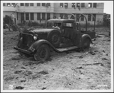 Photograph of a machine-gunned army truck at Hickam Field, Hawaii, after the attack on Pearl Harbor