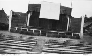 Tadji, New Guinea. c. 1944-12. The "Century" open air theatre constructed by personnel of 71 Wing RAAF. It was used for cinema screenings and theatre productions. Note the film hanging in front of ..