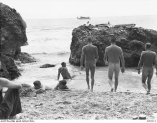 KILIGIA, PAPUA, NEW GUINEA. 1944-04-03. TROOPS FROM HEADQUARTERS 5TH AUSTRALIAN DIVISION ON THE 50 YARD BEACH WHICH IS JUST DEEP ENOUGH TO PERMIT BATHERS TO STRETCH OUT. SWIMMERS NEED TO PICK THEIR ..