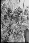 Pig festival, pig sacrifice, Kompiai: war allies at ritual fence, man on left holds bundle of salted pork