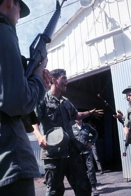 SSGT Richard Bishop, a Marine Corps instructor, critiques the performance of a group of Air Force security policemen who have just completed an anti-terrorist operation. The policemen are participating in an anti-terrorist exercise being conducted by the 1st Marine Brigade School