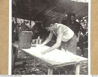 FINSCHHAFEN AREA, NEW GUINEA. 1943-11-11. V165759 PRIVATE J. J. MAGUIRE, BAKER OF THE 4TH AUSTRALIAN FIELD BAKERY MAKING PASTRY FOR MEAT PIES