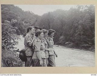 LAE, NEW GUINEA, 1945-05-18. PERSONNEL FROM AUSTRALIAN WOMEN'S ARMY SERVICE BARRACKS STANDING ON THE BANKS OF THE BUSU RIVER DURING A CONDUCTED TOUR OF THE AREA ARRANGED BY ARMY AMENITIES SERVICE. ..