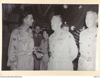 LAE, NEW GUINEA, 1945-12-01. MAJOR-GENERAL H.C.H. ROBERTSON, GENERAL OFFICER COMMANDING FIRST ARMY (2) TALKING TO WARRANT OFFICER 1 H.N. BYRNE, PRESIDENT OF THE SERGEANTS' MESS (1) DURING THE ..