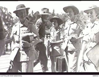 MILFORD HAVEN, NEW GUINEA, 1945-12-14. OFFICERS OF THE AUSTRALIAN ARMY WOMEN'S MEDICAL SERVICE WAITING THEIR TURN TO EMBARK ABOARD THE AUSTRALIAN TROOPSHIP SS MANUNDA