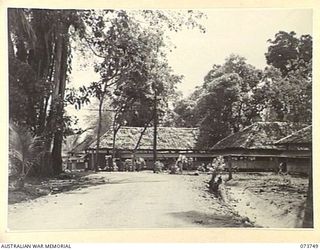 LAE, NEW GUINEA. 1944-06-07. THE DEPUTY ASSISTANT DIRECTOR ORDNANCE SERVICE BUILDING (AT THE BACKGROUND), WITH THE DEPUTY ASSISTANT DIRECTOR ORDNANCE SERVICE HUT AT HEADQUARTERS NEW GUINEA FORCE, ..