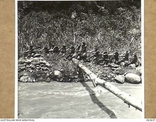 FARIA RIVER, RAMU VALLEY, NEW GUINEA. 1944-01-18. MEMBERS OF D COMPANY, 2/9TH INFANTRY BATTALION HAULING A BIG LOG INTO POSITION TO BE USED AS A BRIDGE ACROSS THE FARIA RIVER JUST BELOW THE ..