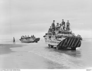 BABIANG, NEW GUINEA. 1944-11-07. TROOPS OF 2/10 COMMANDO SQUADRON ABOARD AMPHIBIOUS DUKWS DURING THEIR JOURNEY TO BABIANG. THE DUKW AT THE REAR IS BOGGED AT THE MOUTH OF THE DRINIUMOR RIVER. ..