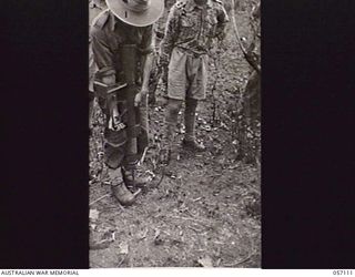SOGERI VALLEY, NEW GUINEA. 1943-09-19. A STUDENT PRACTISING COCKING THE PROJECTOR INFANTRY TANK ATTACK MARK 1 IN PREPARATION FOR THE TEST OF THE PROJECTOR AGAINST JAPANESE PILLBOXES