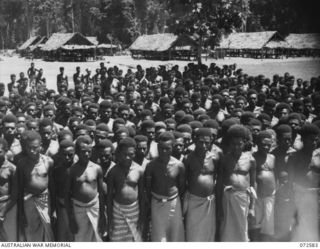 MALAHANG, NEW GUINEA. 1944-04-23. NATIVES IN THE NATIVE LABOUR CAMP, AUSTRALIAN NEW GUINEA ADMINISTRATIVE UNIT, AT THE CAMP COMPOUND DURING THE VISIT OF THE HONOURABLE E.J. WARD, MINISTER FOR ..