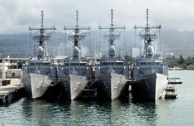 Four U.S. Navy guided missile frigates are moored side by side in the harbor during Exercise RimPac '88. They include, from left: the guided missile frigates USS DUNCAN (FFG-10), the USS MAHLON S. TISDALE (FFG-27), the USS LEWIS B. PULLER (FFG-23) and the USS WADSWORTH (FFG-9)