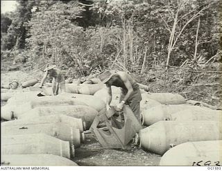 TADJI NEAR AITAPE, NORTH EAST NEW GUINEA. C. 1944-09. DESTINATION JAPANESE TARGETS, 2000 LB BOMBS AT A DUMP NEAR AITAPE ARE BEING FITTED WITH TAILS BY 33000 FLIGHT SERGEANT F. JAMES, BATHURST, NSW ..