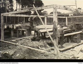 Lae, New Guinea. 1944-07-26. Members of 2/3rd Forestry Company in the Busu Forest, erecting one of the unit's portable sawmills