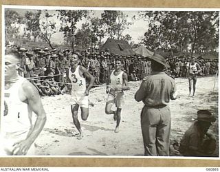 NEW GUINEA. 1943-11-20. FINISH OF THE FIRST HEAT OF THE 440 YARDS OPEN CHAMPIONSHIP AT THE SPORTS OF THE 18TH AUSTRALIAN INFANTRY BRIGADE, WHICH WERE HELD TO CELEBRATE THE FOURTH ANNIVERSARY OF THE ..