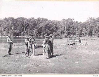 HANSA BAY, NEW GUINEA. 1944-09-07. A PATROL FROM NO.12 PLATOON, B COMPANY, 25TH INFANTRY BATTALION CROSSING THE BOROI RIVER BY MEANS OF A HAND OPERATED PUNT ON THEIR RETURN TO CAMP AFTER A THREE ..