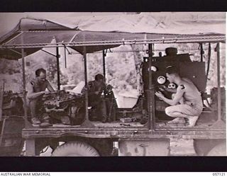 SEVENTEEN MILE, NEW GUINEA. 1943-09-23. MEMBERS OF THE 2/1ST AUSTRALIAN ARMY TOPOGRAPHICAL SURVEY COMPANY, OVERHAULING THEIR EQUIPMENT. LEFT TO RIGHT: VX51225 CORPORAL R. BALL; VX22472 SAPPER J. A. ..