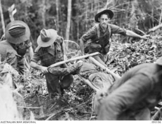 WEWAK AREA, NEW GUINEA, 1945-06-17. STRETCHER BEARERS CARRYING OUT CASUALTIES DURING THE ATTACK BY B COMPANY, 2/8 INFANTRY BATTALION AGAINST HILL 2. IDENTIFIED PERSONNEL ARE:- PTE M.S. ROBERTSON ..