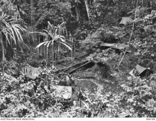 CANNING'S SADDLE, NEW GUINEA. 1944-01-21. THE ADVANCED REGIMENTAL AID POST (FOREGROUND) AND THE KITCHEN OF THE 2/12TH INFANTRY BATTALION (BACKGROUND). THE REGIMENTAL AID POST IS MANNED BY PERSONNEL ..