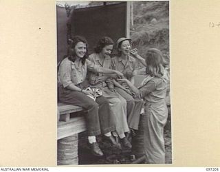 WEWAK POINT, NEW GUINEA. 1945-09-28. MEMBERS OF THE DARYA COLLIN BALLET TROUPE, CURRENTLY TOURING THE SOUTH WEST PACIFIC AREA TO ENTERTAIN TROOPS BEING GIVEN ATEBRIN TABLETS TO PREVENT MALARIA. THE ..