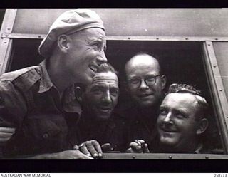 POMPOM VALLEY, NEW GUINEA. 1943-10-26. MEMBERS OF THE 7TH AUSTRALIAN DIVISION CONCERT PARTY ABOARD THEIR BUS. LEFT TO RIGHT:- VX17900 SERGEANT (SGT) D. C. LEED; NX31048 STAFF SERGEANT E. C. DUNN; ..